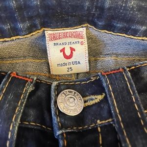 Light worn True Religion Jeans.
